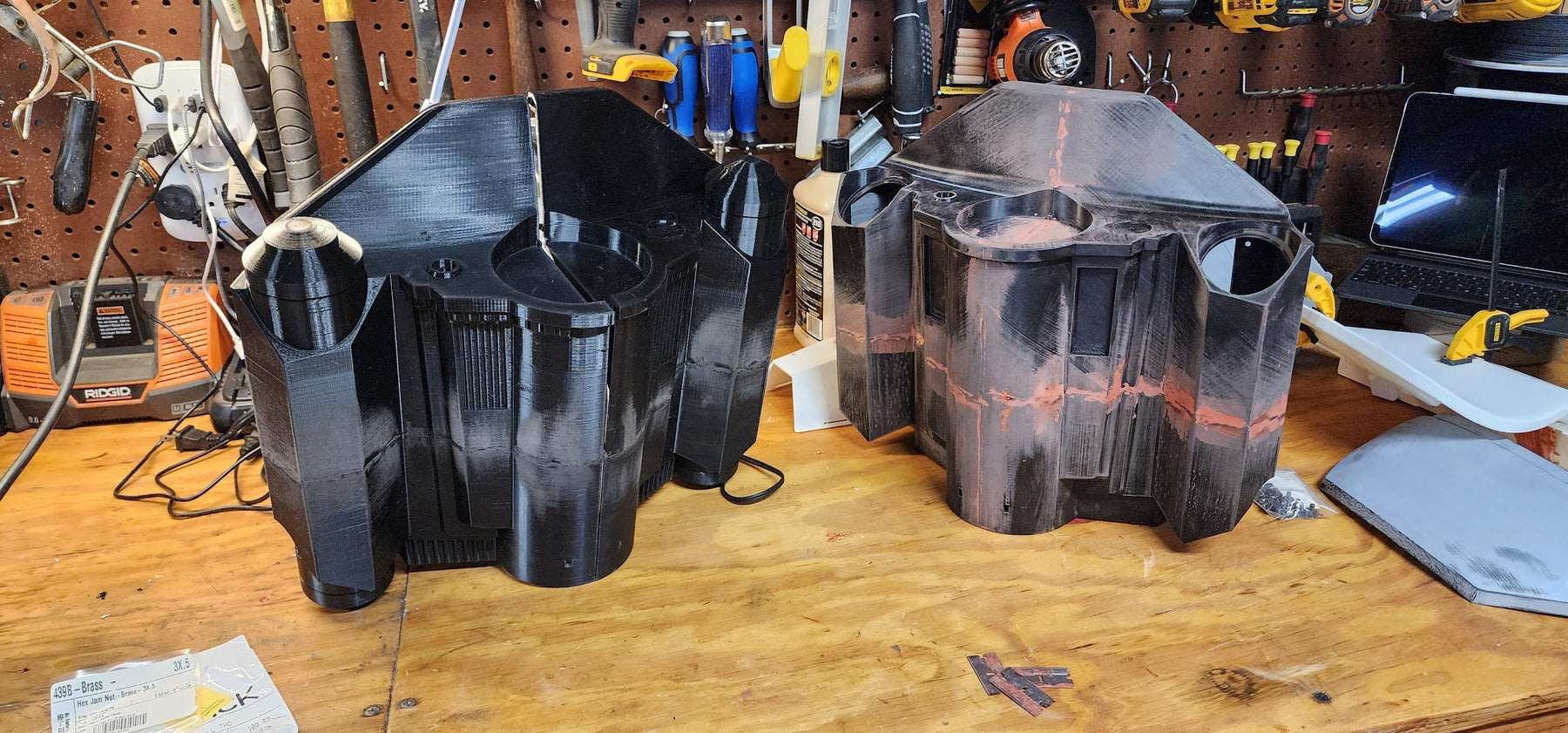 Raw 3D printed armor parts laid out for support removal and seam filling