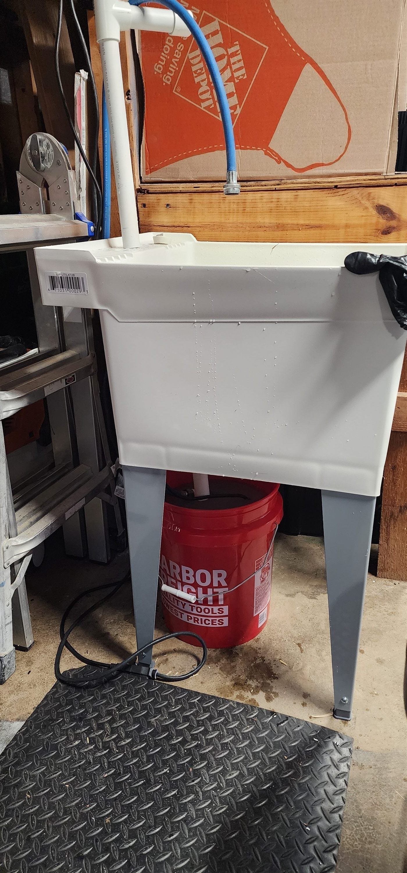 Wet sanding station: utility sink on a stand over a 5-gallon bucket with recirculating pond pump