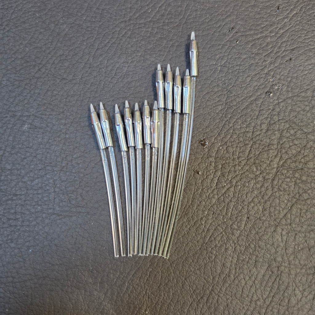 Twelve Alumaluster-finished beskar dart tips fanned loose
