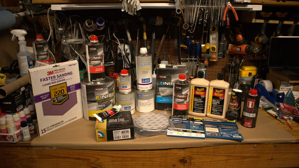 Sandpaper, filler, paint and polish on the workshop bench