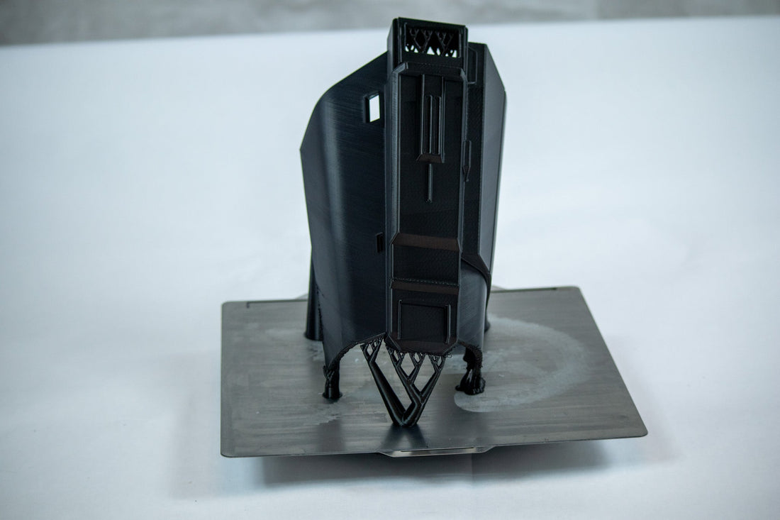 A vertically printed gauntlet part with supports on the print bed