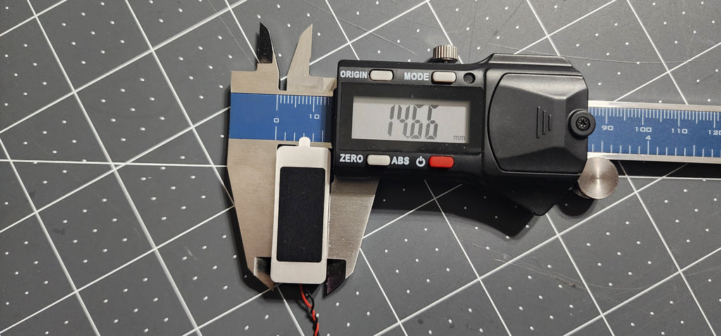 Digital caliper measuring the box speaker width at 15 mm