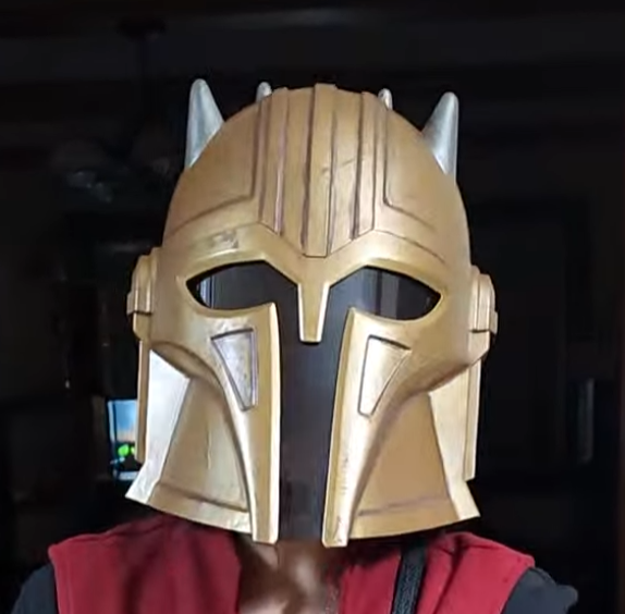 The Armorer gold helmet with silver horns